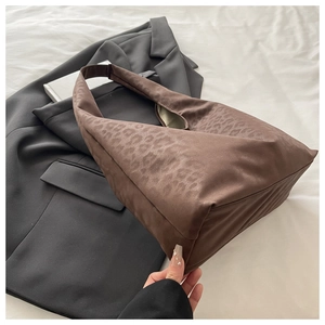 Close-up of leopard print tote bag with soft suede texture and wide shoulder strap