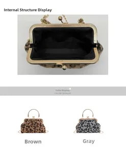 Detail of leopard print shell bag featuring a gold spherical clasp and spacious interior
