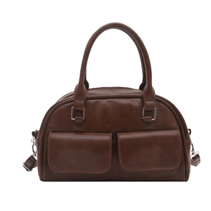 Vintage brown leather bowling bag with twin front flap pockets and cylindrical handles