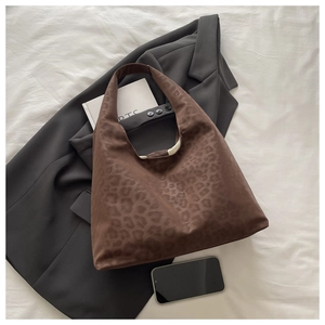 Close-up of leopard print hobo bag in suede texture with professional styling