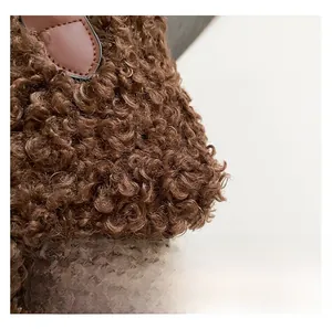 Close-up of curly brown teddy faux fur texture with high-quality brown leather strap