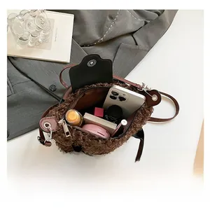 Interior capacity of plush fleece hobo bag showing smartphone and makeup items