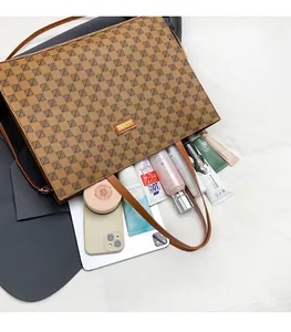 Detail shot of the spacious vintage tote bag interior with tablet and cosmetics