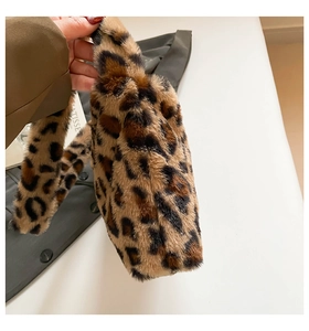 Close-up of fluffy faux fur leopard print handbag texture and soft plush surface