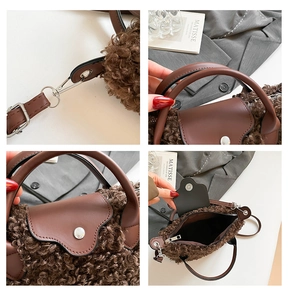 Detail of brown faux fur handbag showing zip closure, PU leather handle and silver metal hooks