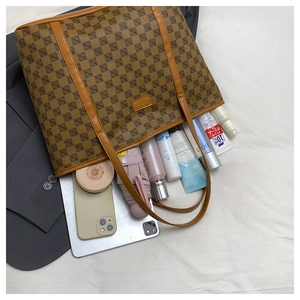 Top-down view of spacious brown monogram tote bag showing large capacity for essentials