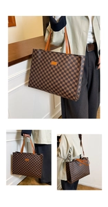 Detail view of large checkered tote bag with brown leather handles and brand logo patch