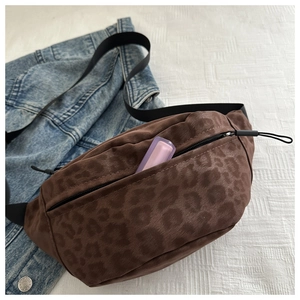 Detail of leopard print crossbody bag with lipstick inside a zippered pocket