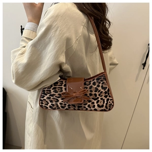 Leopard print underarm bag with velvet texture and brown patent leather bow detail