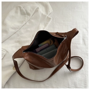 Interior detail of large brown vintage tote bag showing ample capacity and zipper pocket