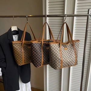 Three elegant checkered tote bags in coffee, light brown and taupe colors on a rack