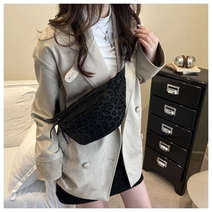 Detail showing leopard print waist bag worn across the chest on a model with blazer