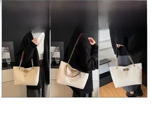 Three-way view of a cream tote bag with gold chain strap and deer charm detail