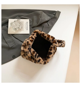 Close-up of leopard print faux fur handbag texture with zipper and soft plush surface