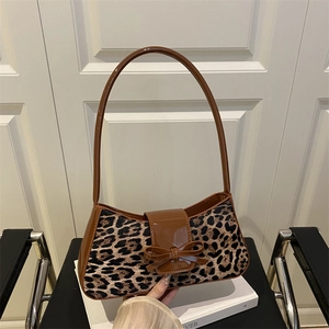 Minimalist leopard print baguette bag with brown leather trim and bow detail