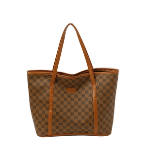 Brown printed tote bag with checkered pattern and dual handles on white background
