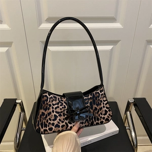 Fashionable leopard print underarm bag with glossy black handle and bow detail