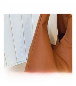 Detail showing the soft, textured synthetic leather surface of the large tote bag