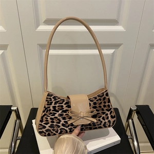 Retro leopard print underarm bag with beige patent leather trim and bow detail