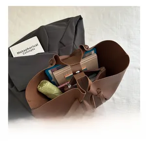 Macro shot showing large storage capacity of chocolate brown tote bag with inner pocket