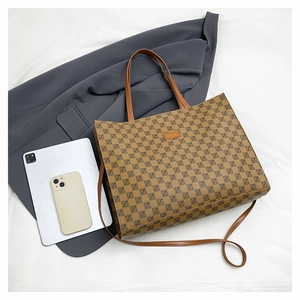 Detailed macro view of retro monogram tote bag with embossed leather fashion logo