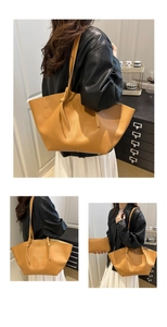 Detail of yellow pebbled leather tote bag with knotted shoulder strap and inner pouch