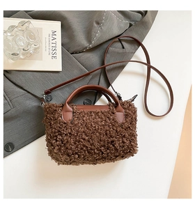 Macro detail of brown plush faux fur handbag with leather handle and shoulder strap
