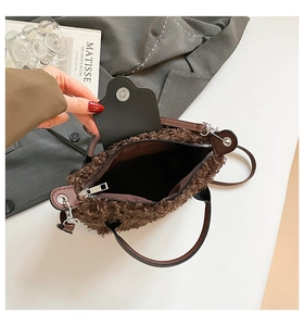 Detail showing the brown plush lamb wool bag interior with leather strap and zipper closure