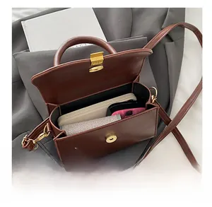 Interior view of brown leather handbag showing space for phone and wallet with magnetic closure