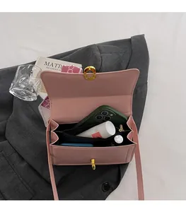 Detailed interior view of pink flap crossbody bag showing multi-layer compartments