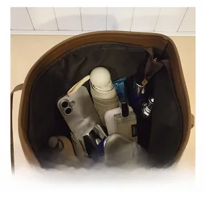 Internal view of large brown leather tote bag showing spacious storage and zip pocket