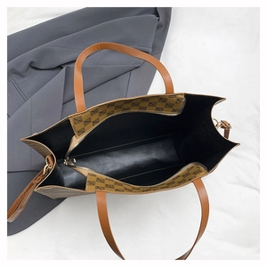 Top view of large tote bag showing brown geometric pattern and spacious inner zip compartment