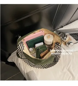 Detailed interior of green tote bag showing spacious capacity for tablets and water bottle