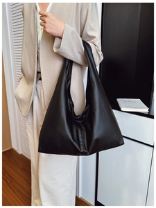 Close-up of black soft PU leather hobo bag showing large capacity and textured surface