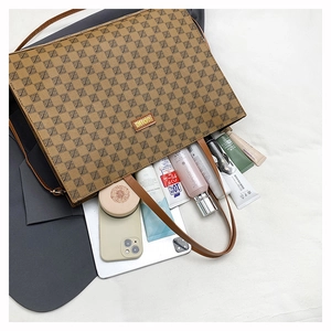 Detail view of large brown vintage tote bag showing interior space and geometric pattern