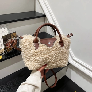 Plush beige faux fur tote bag with brown leather handles and silver metal hardware details