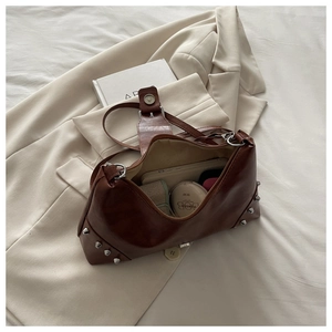Top view of brown retro leather shoulder bag showing large interior capacity and silver rivets