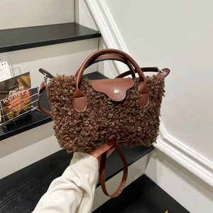 Brown teddy plush shoulder bag with leather accents and silver buckle for winter fashion