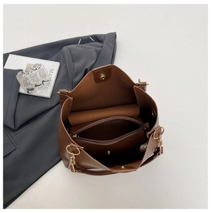 Detail view of brown leather tote bag showing internal compartments and magnetic closure