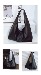 Detailed view of large black minimalist hobo bag showing matte PU leather texture and soft drape