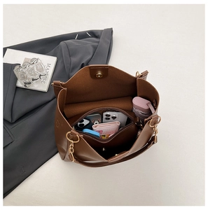Interior view of large brown tote bag showing spacious compartments for daily items