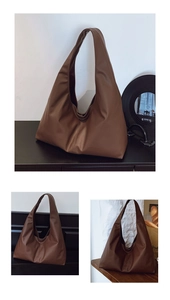 Detailed close-up of brown oversized tote bag in matte PU leather with hobo design
