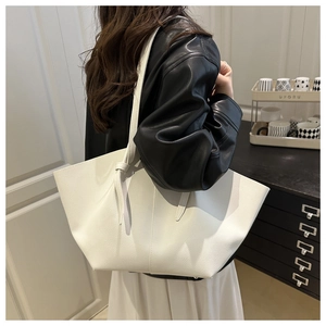 Detail of white lychee grain leather tote bag with stylish knot strap and large capacity