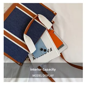 Macro view of denim tote bag interior showing large capacity for books and phone