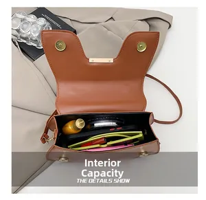Internal capacity of the brown saddle bag showing smartphone and daily essentials
