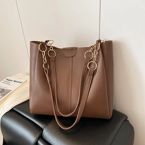 Minimalist brown faux leather tote bag with gold chain handle and shoulder strap