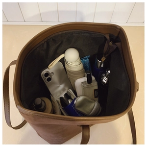Top view of spacious brown tote bag interior with organized pockets and large capacity