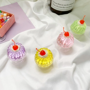 Close-up of cute 3D jelly cake phone grips with cherry decor on white fabric