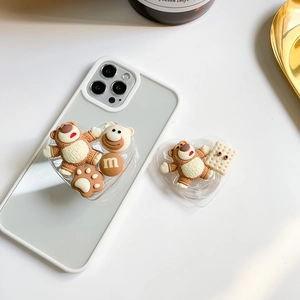 Detail view of 3D resin bear and heart-shaped collapsible phone grip on white case