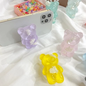 Close-up of cute transparent bear phone grip in multiple pastel macaron colors